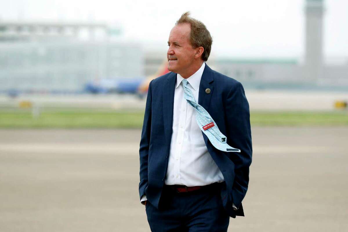 FILE - In this June 28, 2020 file photo, Texas' Attorney General Ken Paxton waits on the flight line for the arrival of Vice President Mike Pence at Love Field in Dallas. (AP Photo/Tony Gutierrez, File)