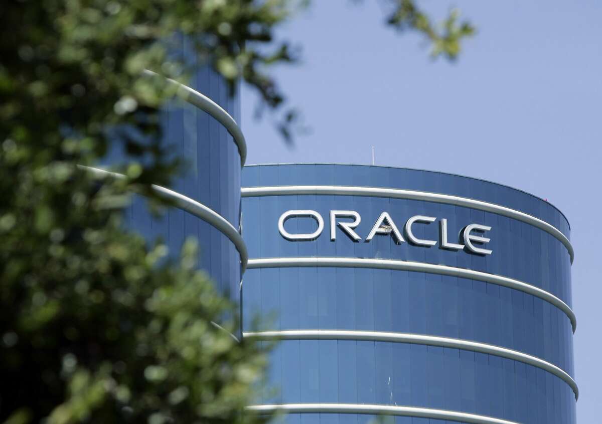 FILE - This June 26, 2007 file photo shows the exterior of Oracle Corp. headquarters in Redwood City, Calif. Tech giant Oracle Corp. said Friday, Dec. 11, 2020 it will move its headquarters from Silicon Valley to Austin, Texas, and let many employees choose their office locations and decide whether to work from home. (AP Photo/Paul Sakuma, File)