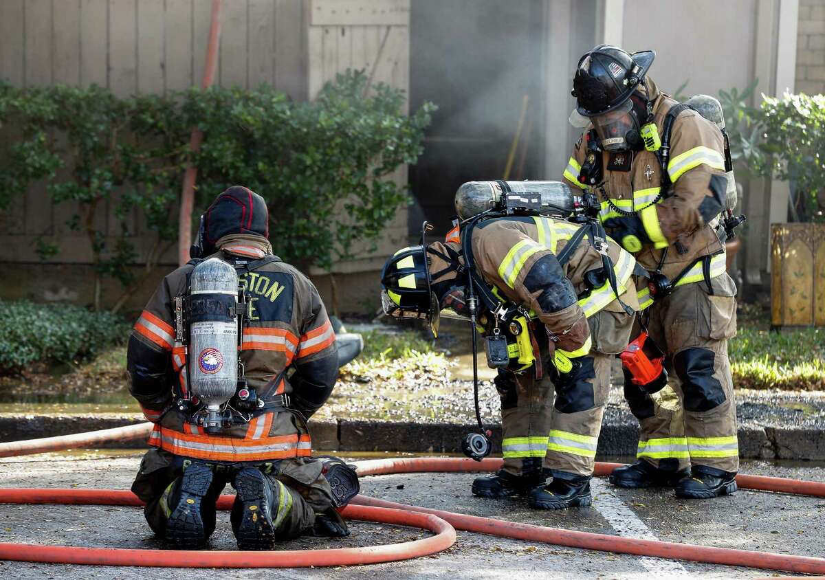 Houston Fire Department firefighters at a two-alarm fire at The Bellfort Apartments complex Thursday, Nov. 19, 2020, in Houston.