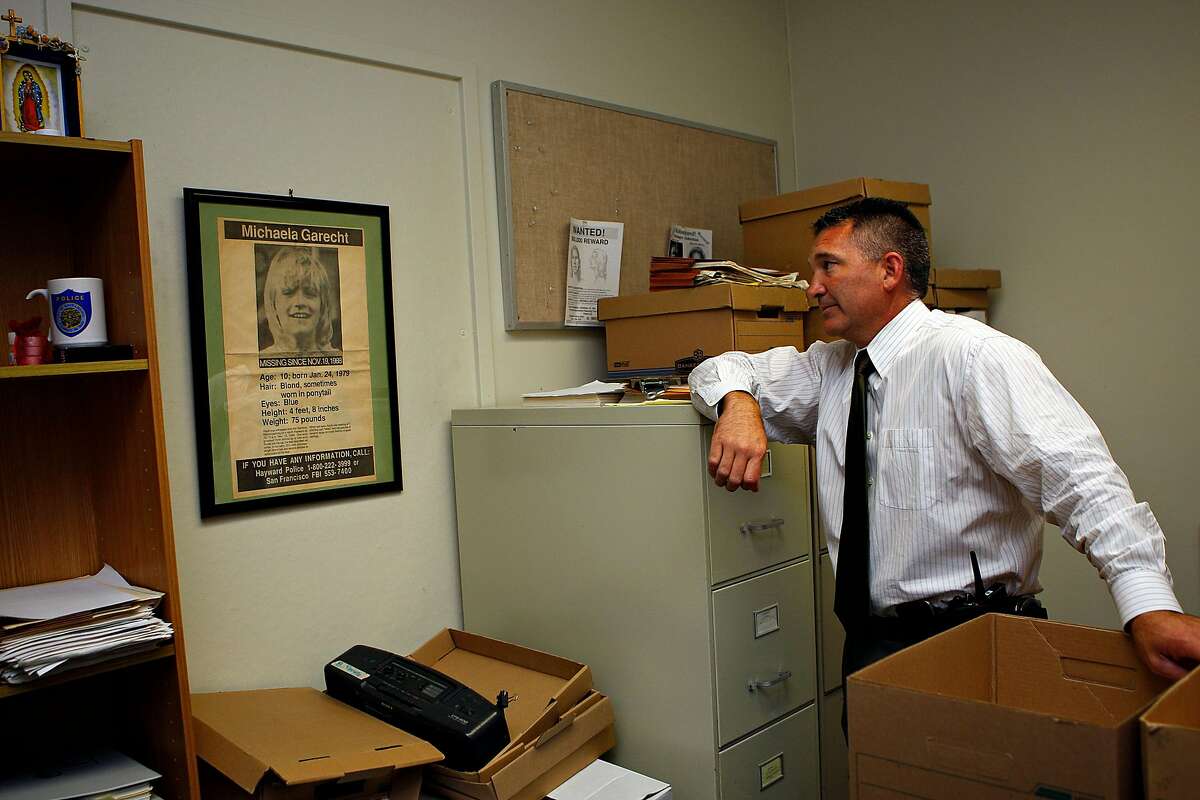Then-Hayward police Sgt. Eric Krimm showing “Michaela's room” at the Hayward police station in 2012. He is looking at a framed ad searching for any information on Michaela Garecht, who was abducted Nov. 19, 1988.