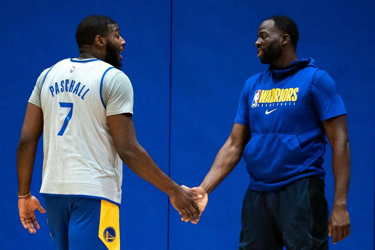 Golden State Warriors' Draymond Green (right) and Eric Paschall (left) at practice at Chase Center in San Francisco, Calif. on Monday, Dec. 14, 2020.