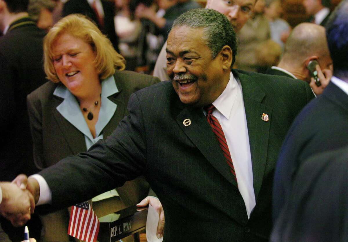 FILE PHOTO -- 2/8/06 / Bridgeport/Stratford State Senator Ed Gomes greets fellow legislators as he enters the House chamber for the governor's State of the State address.
