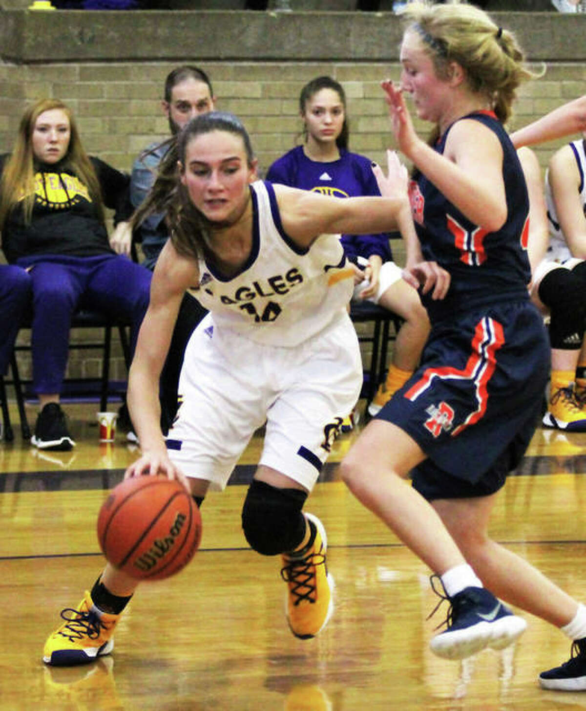 CM’s Hannah Sontag (left) drives on Rochester’s Abby Walton during a Thanksgiving tournament game in Taylorville as a sophomore in November 2018. Sixteen days later, Sontag suffered what proved to be a career-ending knee injury.