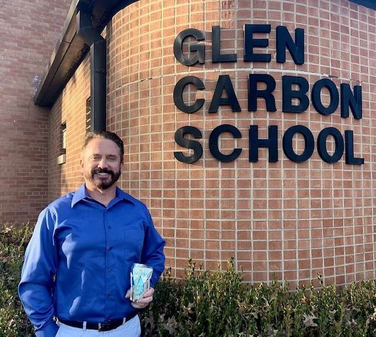 Kraft Heinz employee Jeff Garde stands in front of Glen Carbon Elementary School after helping deliver a donation of water-filled Capri Sun pouches. Garde, a Glen Carbon resident, has children who were once students at the elementary school.