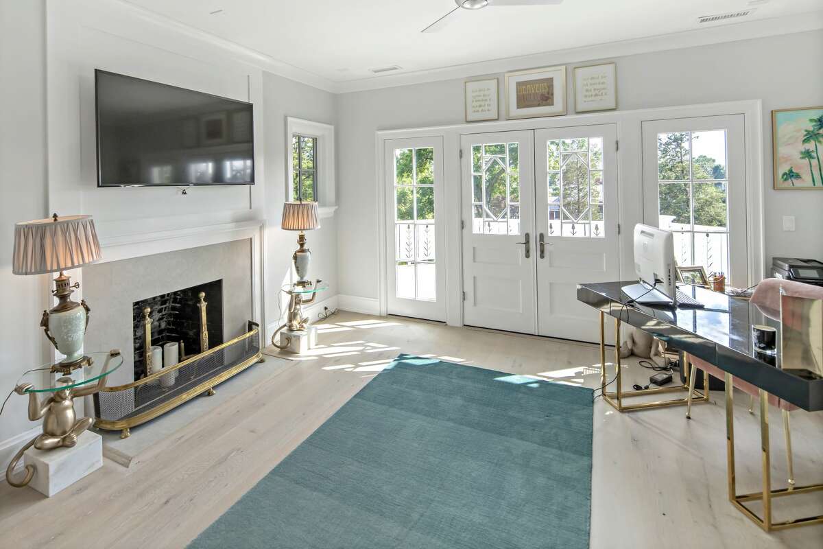 Second floor sitting room with fireplace and balcony at 2 Hidden Hill Road, Westport. Then again, this house and its 0.83-acre level property provide so many sophisticated living and entertaining amenities that, as the agent says, friends and family will never want to leave; and luckily, there is room for everyone: a nursery, au pair quarters, teen suite, in-law suite, art studio, home-schooling center, and many more options. There is also ample space to create a comfortable work-from-home arrangement in the large study or in other spaces throughout the house.