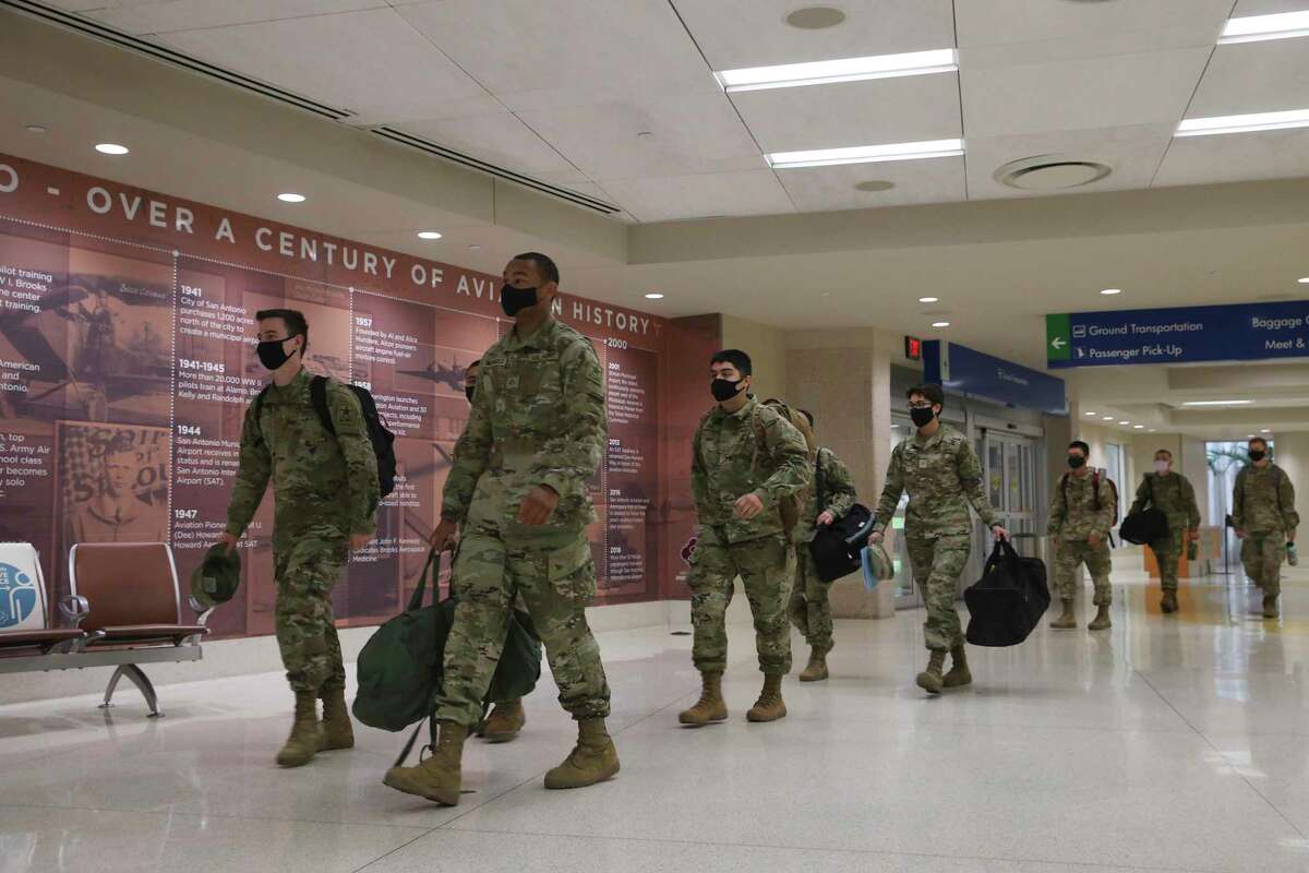 Army Pvt. Kevin Rinke, 18, left, of Spanaway, Wash., and Pfc. Marlon Brownfield, 19, of Hampton, Ga., arrive with other soldiers at San Antonio International Airport on their way to their holiday break.