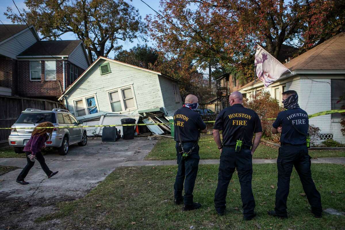 Houston firefighters stand by at the scene of a building collapse near the intersection of Usener and White Oak Tuesday, Dec. 22, 2020 in Houston.