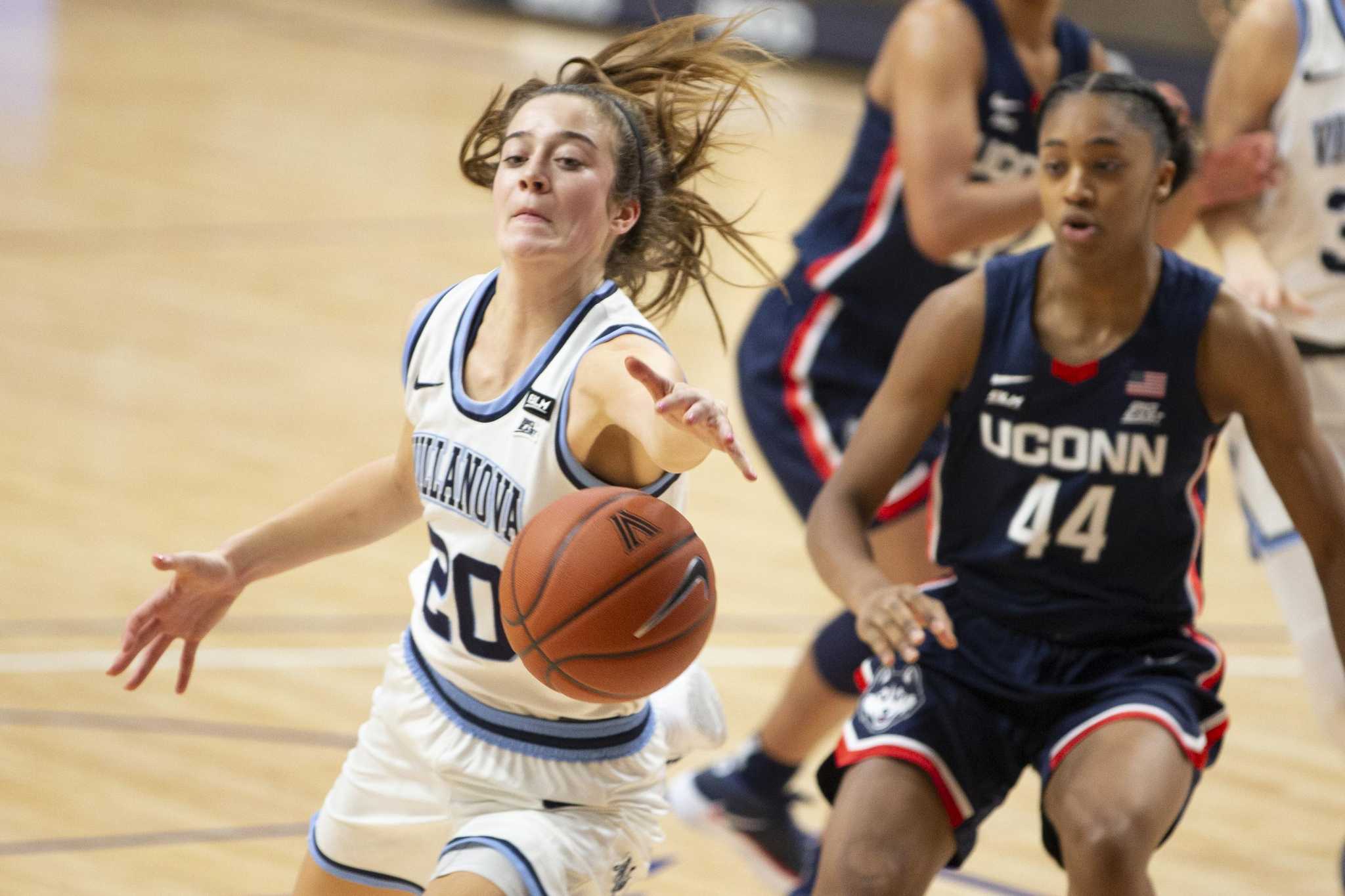 HARTFORD, CT - FEBRUARY 09: UConn Huskies guard Evina Westbrook (22)  defended by Villanova Wildcats forward Maddy Siegrist (20) during a college  basketball game between Villanova Wildcats and UConn Huskies on February