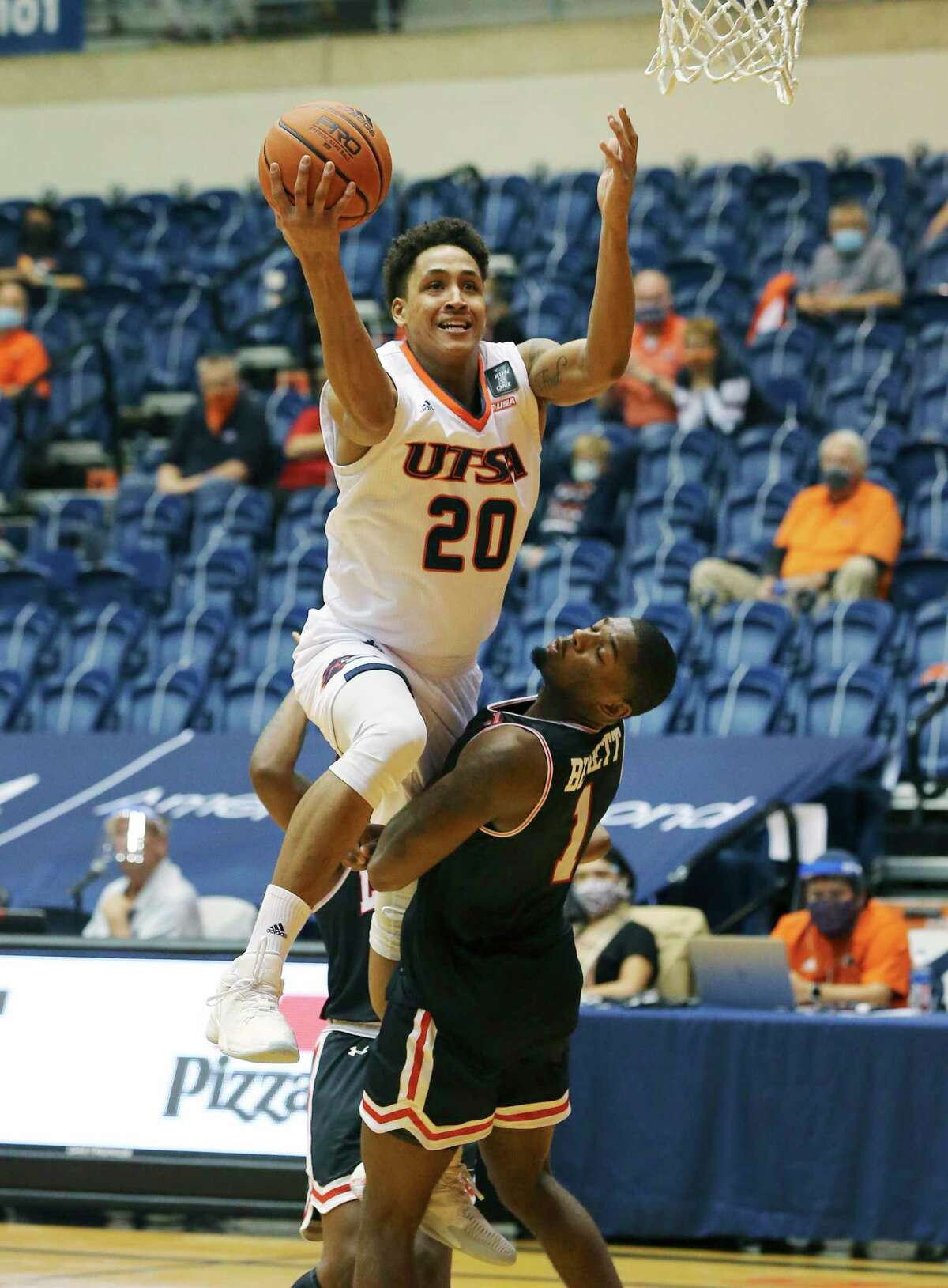UTSA's Eric Parrish (20) gets called for a charge against Lamar's Quinlan Bennett (01) during their basketball game at UTSA on Tuesday, Dec. 22, 2020.