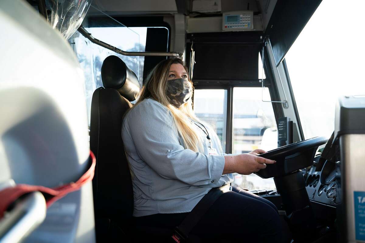 JorDann Crawford, 29, poses for a photo at the beginning of her morning shift as a bus driver at the San Rafael Transit Center. She will get to keep her job after layoffs were rescinded.