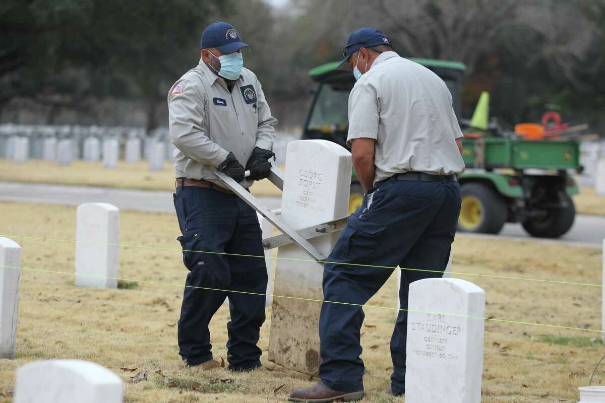 Ft. Sam Houston National Cemetery workers remove two German WWII graves with Nazi inscriptions and replace them with new headstones on Dec. 23, 2020.