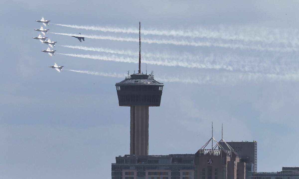 The U.S. Air Force Thunderbirds - as part of the America Strong campaign to salute Americans who are contending with the Covid-19 pandemic - perform a flyover past the Tower of the Americas in San Antonio on Wednesday, May 13, 2020. The jets flew in formation over various locations around the city before heading toward Austin. Near Alamo Stadium, the streets and parking lots were filled with people who wanted to get a glimpse of the Thunderbirds paying homage to community.