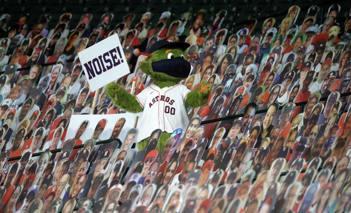 Houston Astros mascot Orbit tries to get the fan cutouts to make some noice during the second inning of an MLB baseball game at Minute Maid Park, Monday, August 24, 2020, in Houston.