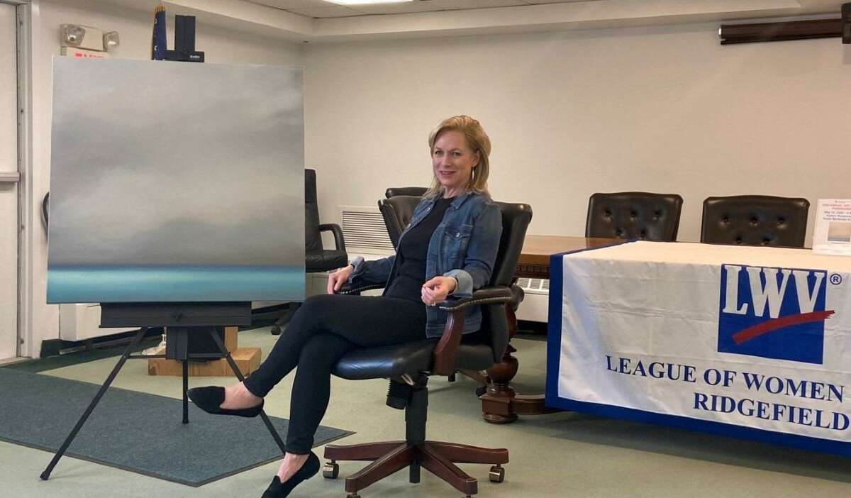 Ridgefield Artist Tina Cobelle-Sturges is pictured with the painting she donated for the League of Women Voters of Ridgefield Art Raffle. The non-partisan organization is going to hold the fundraiser during a virtual event January 12, at 11 a.m. in conjunction with Ridgefield Suffragist Alice Paul's birthday.