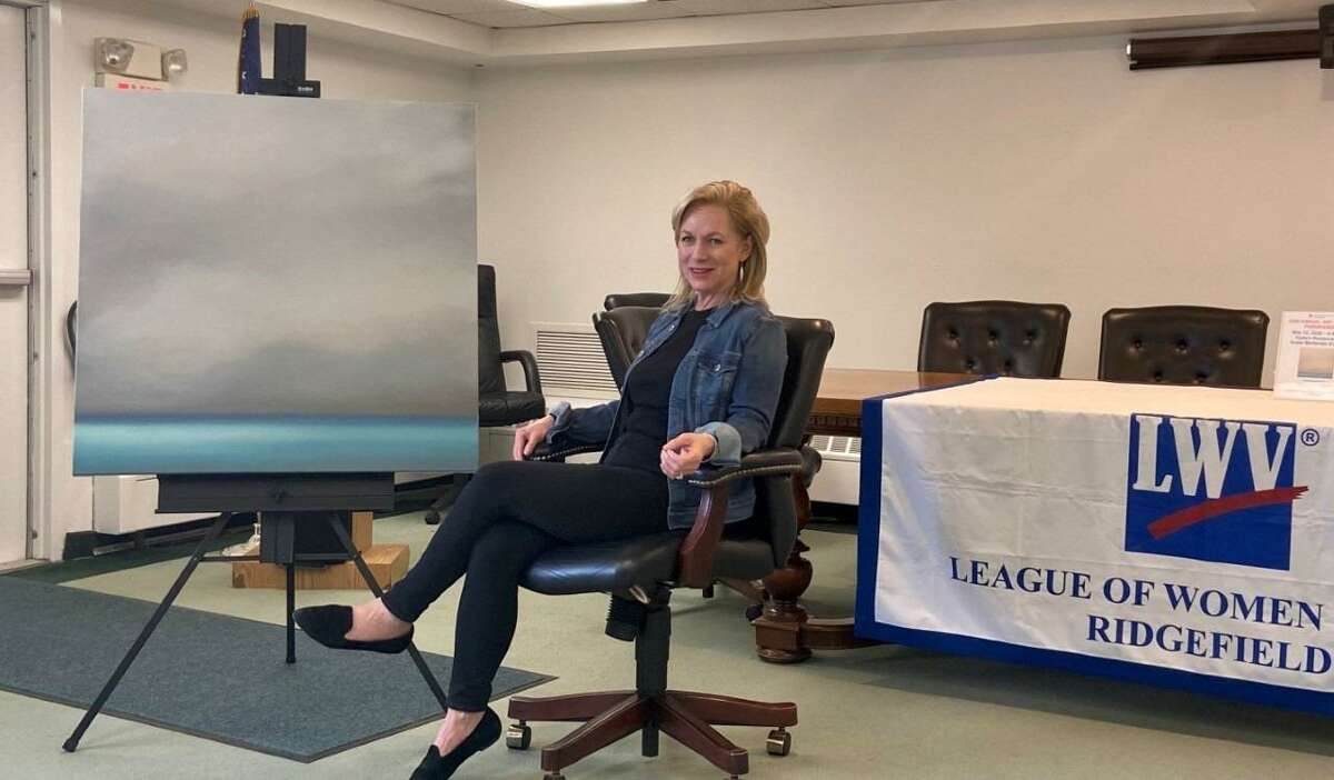 Ridgefield Artist Tina Cobelle-Sturges is pictured with the painting she donated for the League of Women Voters of Ridgefield Art Raffle. The non-partisan organization is going to hold the fundraiser during a virtual event January 12, at 11 a.m. in conjunction with Ridgefield Suffragist Alice Paul’s birthday.