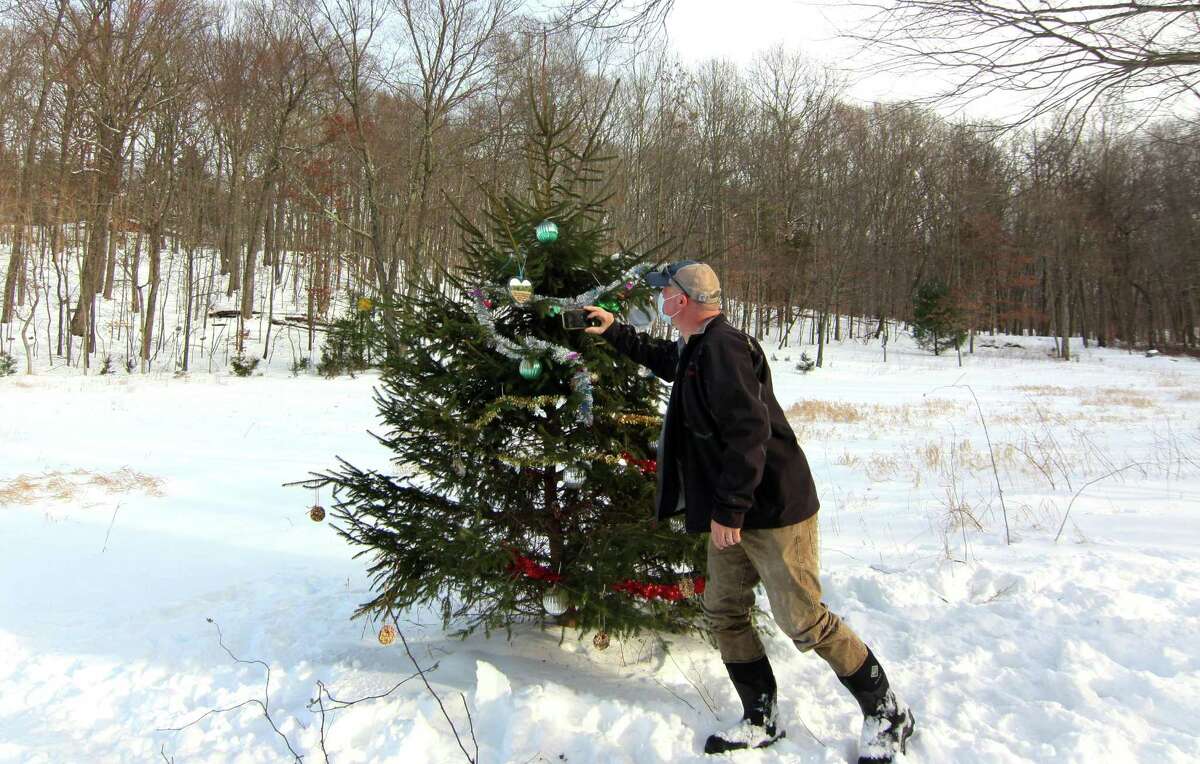 Joe Welsh, President of the Shelton Land Conservation Trust snaps photos of the trust's