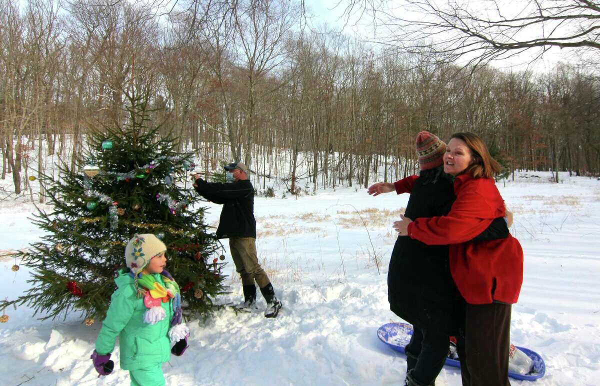 Members and friends of the Shelton Land Conservation Trust gather to decorate a