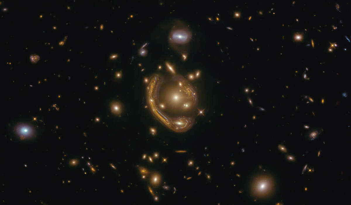 The narrow galaxy elegantly curving around its spherical companion in this image is a fantastic example of a rare phenomenon. This image was taken with the NASA/ESA Hubble Space Telescope.