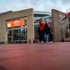 People stand in front of Toyota Center after it was announced that the Rockets opening night game against the Oklahoma City Thunder was being postponed, Wednesday, Dec. 23, 2020, in Houston.