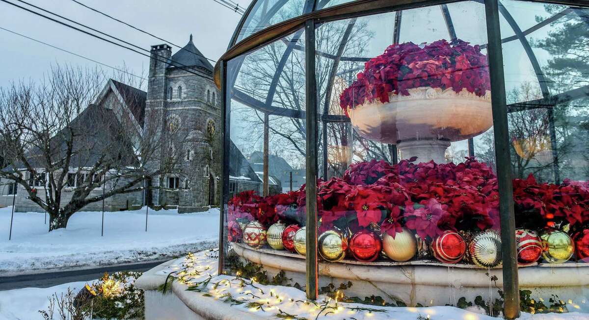 The First Congregational Church of Ridgefield stands near the Cass Gilbert Fountain, decorated for the holidays. James T.Watson, senior minister of the church, was reminded this year of the Christmas carol and poem
