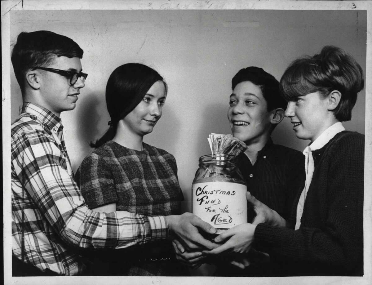 Collecting money for needy older folks are Bill Rheinard, Joan Simmons - accepting money, Mike Trance, and Debby Hamilton. Dec. 24, 1965 (Jack Madigan/Times Union Archive)