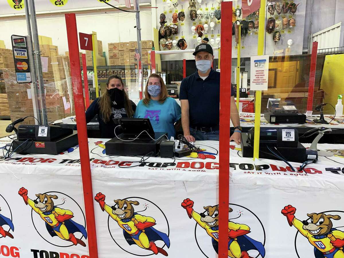 Band director Tabatha Cooper, Beth Sweeten and John Wheat wait for customers to come through the checkout at the TOPDOG Fireworks 20432 Northwest Fwy. between Huffmeister and FM 1960. A percentage of the purchases made at the store go to support the band program at Tomball Memorial High School.