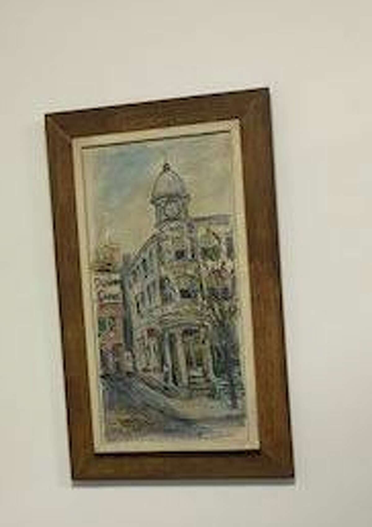 This painting in Editorial Page Editor Jacqueline Smith’s office depicts the home of The News-Times on Danbury’s Main Street before the newspaper operations expanded to a brick building at 333 Main St. Two years ago, offices moved to 345 Main St.