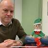 Stephen Robinson with the artificial intelligence elf he recently created. The elf is able to answer questions posed to it.