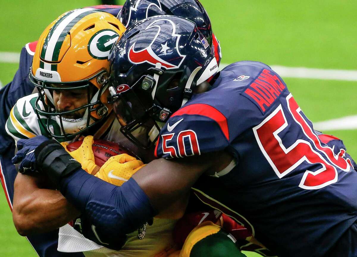Texans linebacker Tyrell Adams introduces himself to Packers wide receiver Darrius Shepherd on a tackle at NRG Stadium in October 2020.