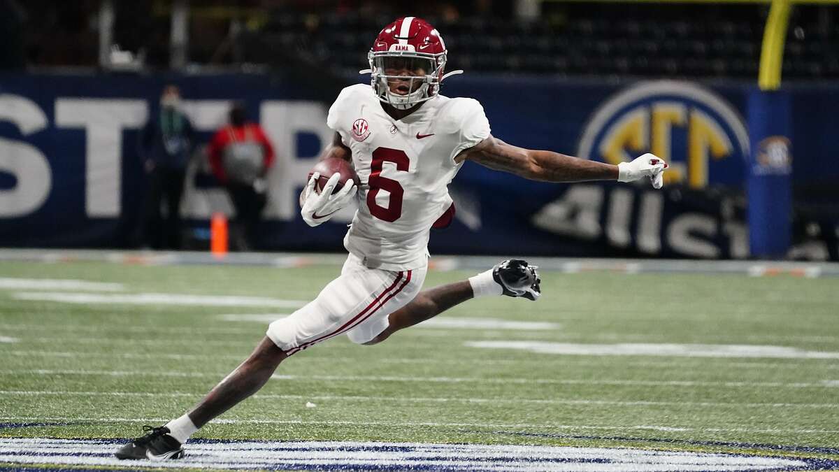 FILE - In this Saturday, Dec. 19, 2020, file photo, Alabama wide receiver DeVonta Smith (6) runs against Florida during the first half of the Southeastern Conference championship NCAA college football game in Atlanta. Smith has been named a finalist for the Heisman Trophy. The Heisman will be awarded Jan. 5 during a virtual ceremony as the pandemic forced the cancellation of the usual trip to New York that for the presentation that usually comes with being a finalist. (AP Photo/Brynn Anderson, File)