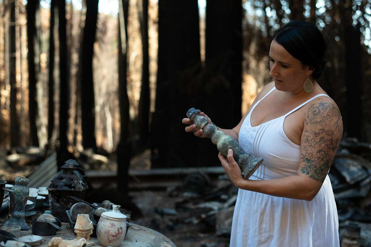 Antonia Bradford shows some of the possessions recovered at the site of her home in Boulder Creek (Santa Cruz County), which was destroyed by the CZU Lightning Complex in September.