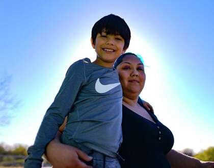 Sandra Treviño hugs her son Frankie Treviño, who was in Loma Park Elementary Kindergarten when a deputy headmaster allegedly held him back physically and broke his elbow.