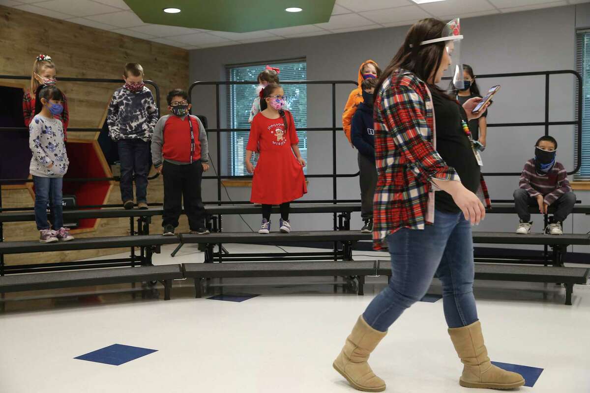 Art and music teacher Taylor Zipp arranges a class of first graders before rehearsing holiday songs at Meyer Elementary School in Hondo on the last day of the fall semester, Dec. 18, 2020. Hondo ISD stopped all remote learning on Nov. 9 with only medical exceptions allowed.