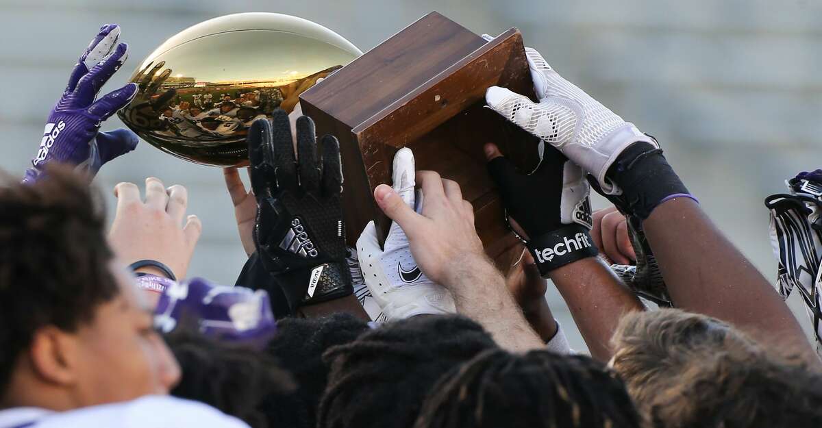 Fort Bend Ridge Point varsity football team holds up their trophy after defeating Humble Atascocita 55-45- at TDECU Stadium in Houston on Saturday, Dec. 26, 2020.