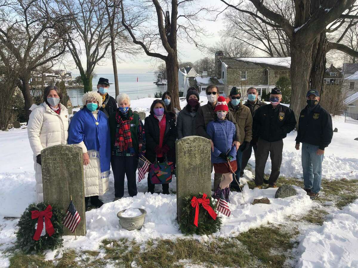 Greenwich in a national tradition by laying wreaths on the graves of two Revolutionary War soldiers buried in the Old Burying Ground. From left, Karen Shapiro, Jolene Mullen, David Wold, Wynn McDaniel, Grace Popp, Karen Popp, Alex Popp, Darcy Popp, Ken Popp, Don Sylvester, Dean Gamanos and First Selectman, Fred Camillo took part.