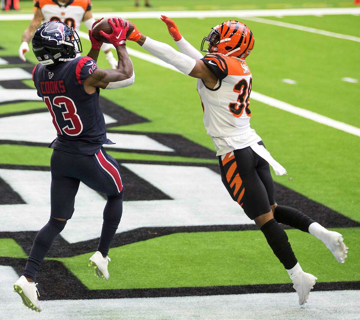 Houston Texans wide receiver Brandin Cooks (13) beats Cincinnati Bengals free safety Jessie Bates (30) into the end zone for a touchdown reception during the second quarter of an NFL football game at NRG Stadium on Sunday, Dec. 27, 2020, in Houston.