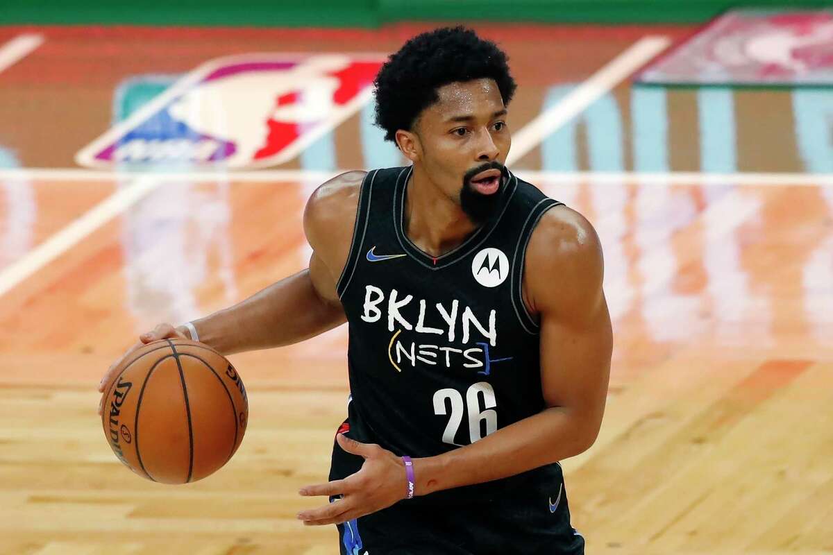 Brooklyn Nets' Spencer Dinwiddie, who tore his ACL on Sunday, plays against the Boston Celtics during the first half of an NBA basketball game, Friday, Dec. 25, 2020, in Boston. (AP Photo/Michael Dwyer)