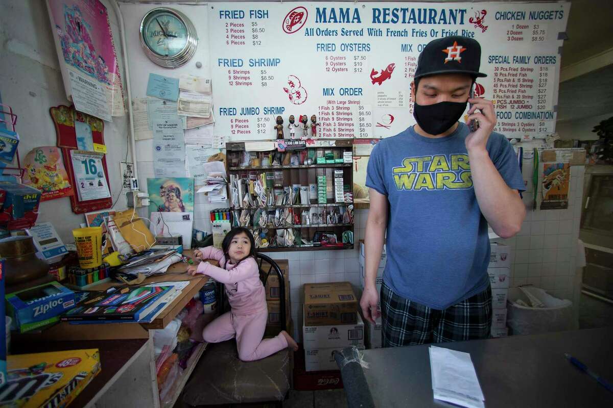 Tommy Huynh takes an order at the front counter of his family's restaurant, Mama Seafood, Wednesday, Dec. 16, 2020 in Houston. The family-run restaurant at Parker at Jensen is located where the city's troubled sewer system has particular problems during heavy rains. Several times a year, rains force raw sewage out of the drain in the middle of the restaurant's kitchen floor.