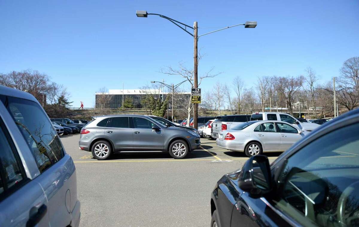 Cars are parked in the Island Beach parking lot near the train station in downtown Greenwich, Conn.