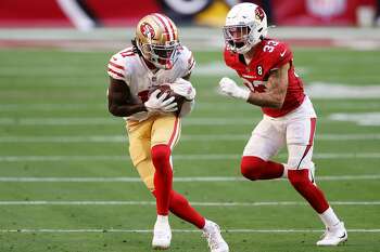 Santa Clara, California, USA. 18th Oct, 2020. San Francisco 49ers wide  receiver Brandon Aiyuk (11) celebrates touchdown with team member in front  of TV screen on Sunday, October 18, 2020, at Levis