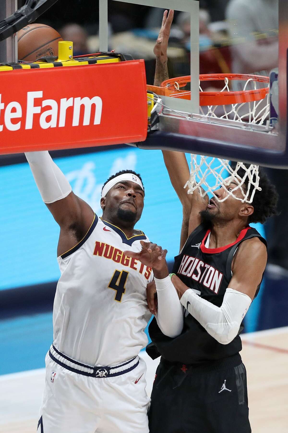 DENVER, COLORADO - DECEMBER 28: Paul Millsap #4 of the Denver Nuggets takes the ball to the basket against Christian Wood #35 of the Houston Rockets in the second quarter at Ball Arena on December 28, 2020 in Denver, Colorado. NOTE TO USER: User expressly acknowledges and agrees that, by downloading and or using this photograph, User is consenting to the terms and conditions of the Getty Images License Agreement. (Photo by Matthew Stockman/Getty Images)