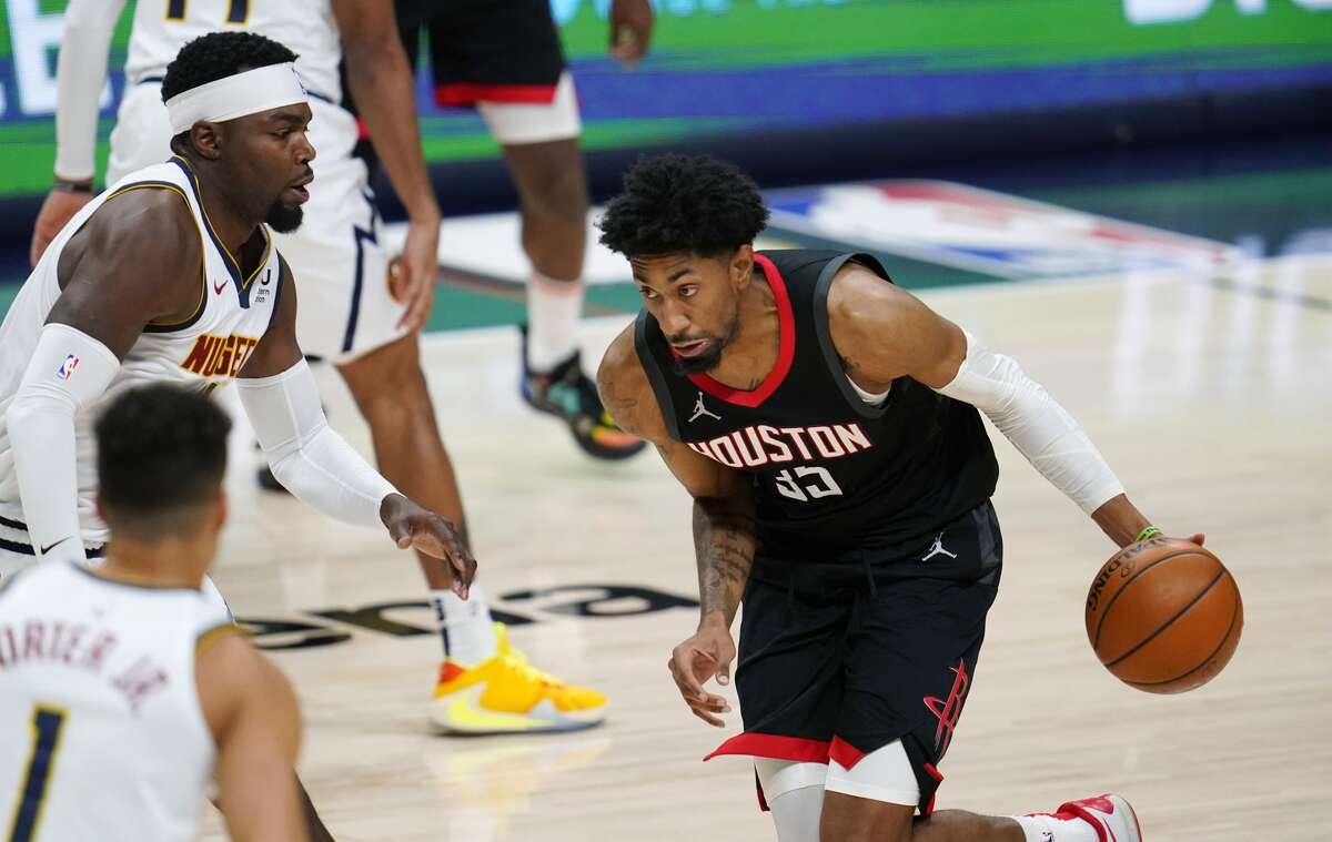 Houston Rockets forward Christian Wood drives as Denver Nuggets forwards Michael Porter Jr., front left, and Paul Millsap defend during the second half of an NBA basketball game Monday, Dec. 28, 2020, in Denver. (AP Photo/David Zalubowski)