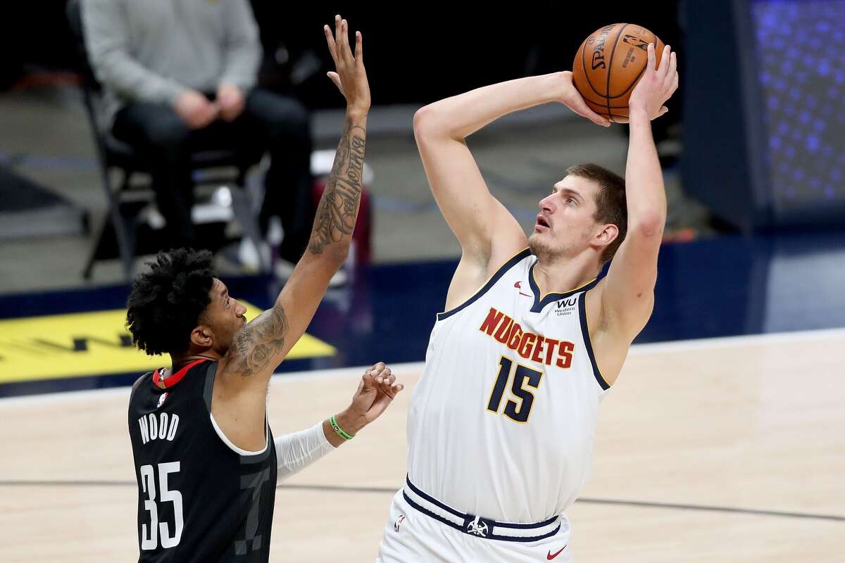 DENVER, COLORADO - DECEMBER 28: Nikola Jokic #15 of the Denver Nuggets puts up a shot over Christian Wood #35 of the Houston Rockets in the first quarter at Ball Arena on December 28, 2020 in Denver, Colorado. NOTE TO USER: User expressly acknowledges and agrees that, by downloading and or using this photograph, User is consenting to the terms and conditions of the Getty Images License Agreement. (Photo by Matthew Stockman/Getty Images)