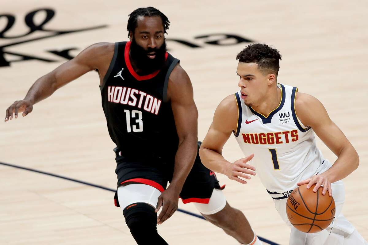 DENVER, COLORADO - DECEMBER 28: Michael Porter Jr #1 of the Denver Nuggets drives against James Harden #13 of the Houston Rockets in the first quarter at Ball Arena on December 28, 2020 in Denver, Colorado. NOTE TO USER: User expressly acknowledges and agrees that, by downloading and or using this photograph, User is consenting to the terms and conditions of the Getty Images License Agreement. (Photo by Matthew Stockman/Getty Images)