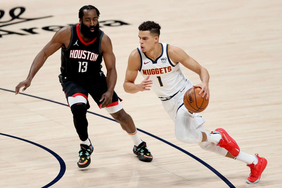 DENVER, COLORADO - DECEMBER 28: Michael Porter Jr #1 of the Denver Nuggets drives against James Harden #13 of the Houston Rockets in the first quarter at Ball Arena on December 28, 2020 in Denver, Colorado. NOTE TO USER: User expressly acknowledges and agrees that, by downloading and or using this photograph, User is consenting to the terms and conditions of the Getty Images License Agreement. (Photo by Matthew Stockman/Getty Images)