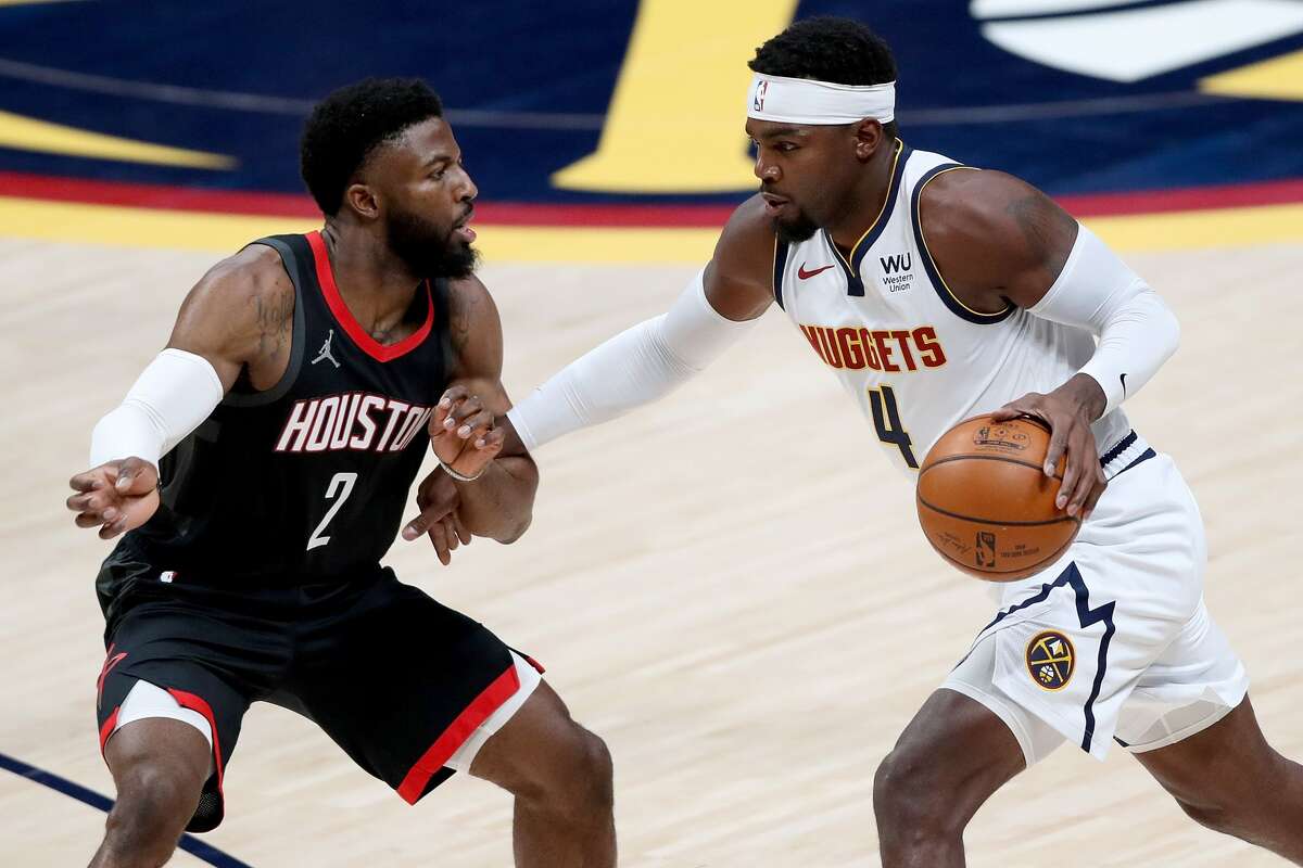 DENVER, COLORADO - DECEMBER 28: Paul Millsap #4 of the Denver Nuggets drives against David Nwaba #2 of the Houston Rockets in the first quarter at Ball Arena on December 28, 2020 in Denver, Colorado. NOTE TO USER: User expressly acknowledges and agrees that, by downloading and or using this photograph, User is consenting to the terms and conditions of the Getty Images License Agreement. (Photo by Matthew Stockman/Getty Images)