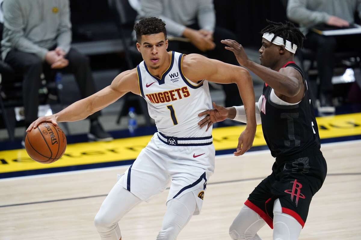 Denver Nuggets forward Michael Porter Jr., left, is defended by Houston Rockets forward Danuel House Jr. during the first half of an NBA basketball game Monday, Dec. 28, 2020, in Denver. (AP Photo/David Zalubowski)