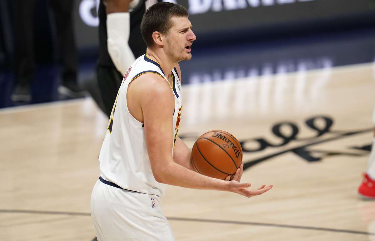 Denver Nuggets center Nikola Jokic appeals to the referees after being called for a charging foul against Houston Rockets forward P.J. Tucker during the first half of an NBA basketball game Monday, Dec. 28, 2020, in Denver. (AP Photo/David Zalubowski)