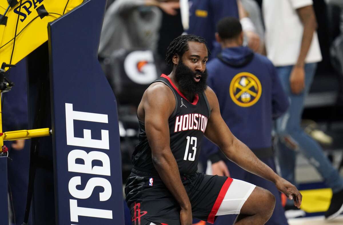 Houston Rockets guard James Harden jumps against the padded standard that holds the backboard before the team's NBA basketball game against the Denver Nuggets on Monday, Dec. 28, 2020, in Denver. (AP Photo/David Zalubowski)