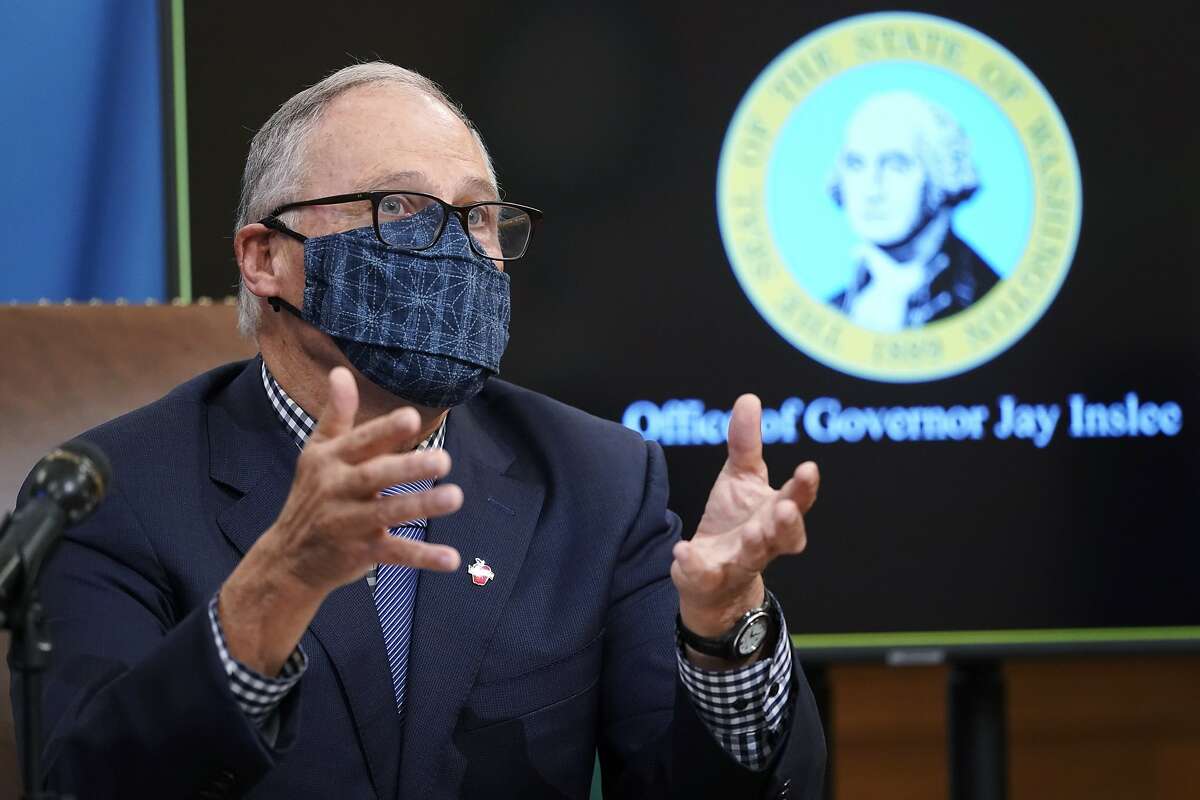 FILE - In this Dec. 17, 2022 file photo, Washington Gov. Jay Inslee talks to reporters at the Capitol in Olympia, Wash. State lawmakers across the country will be convening in 2022 with the continuing COVID-19 pandemic rippling through much of their work — and even affecting the way they work. After 10 months of emergency orders and restrictions from governors and local executive officials, some state lawmakers are eager to reassert their power over statewide decisions shaping the way people shop, work, worship and attend school (AP Photo/Ted S. Warren, File)